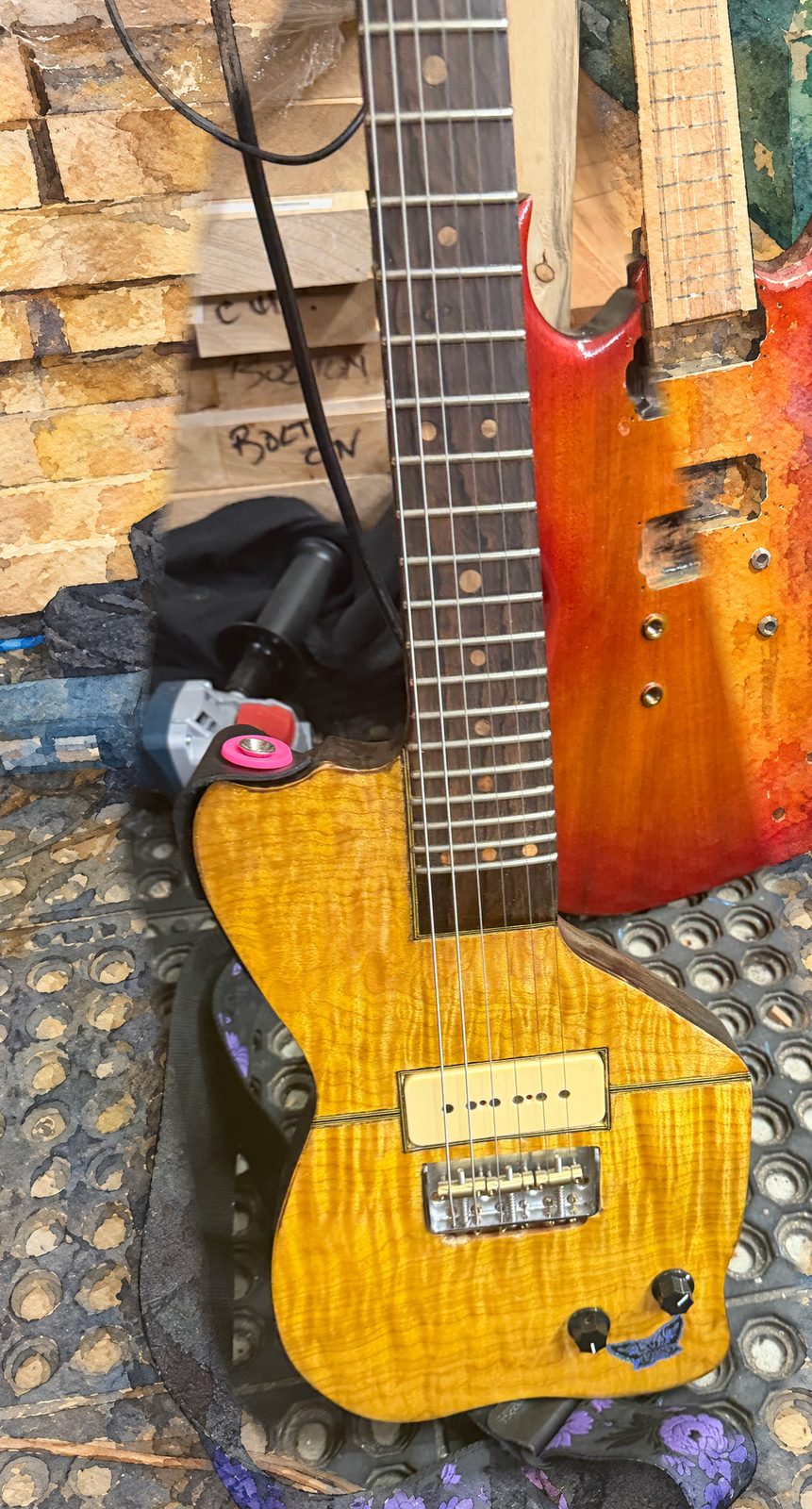 Thunderbird. Flame maple, ziricote fretboard, hand-wound Q180. Workshop photo, painted ground.